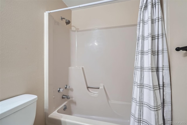 bathroom featuring shower / bath combination with curtain and toilet