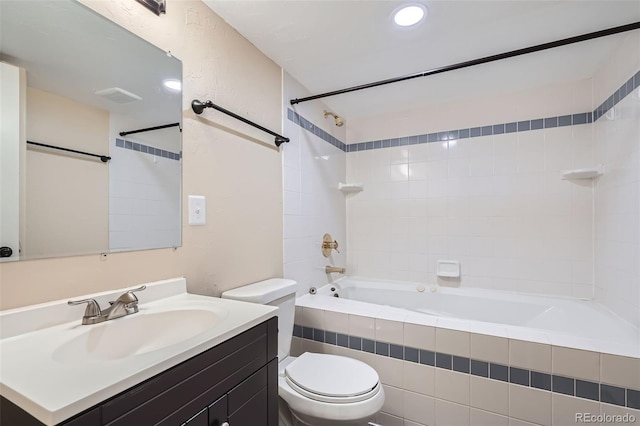 full bathroom featuring toilet, vanity, and tiled shower / bath