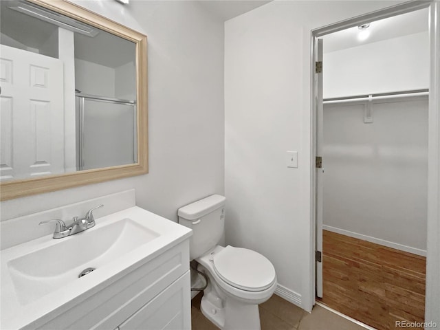 5550 W 80th Pl Unit 20, Arvada, CO 80003 - full bath featuring vanity, a walk in closet, a shower with door, and tile patterned flooring