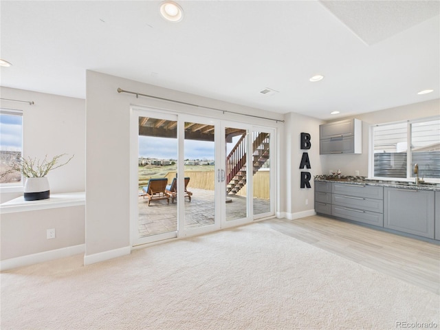 interior space featuring light carpet, plenty of natural light, and recessed lighting