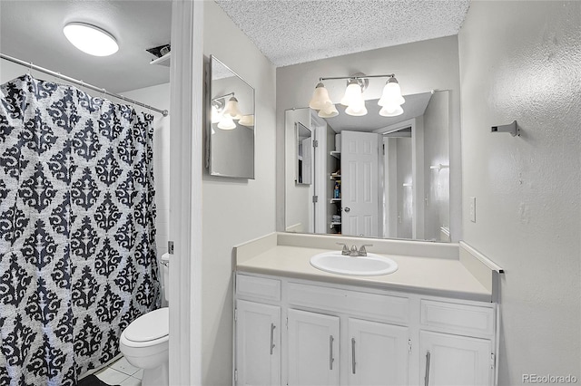 bathroom featuring walk in shower, tile patterned flooring, a textured ceiling, toilet, and vanity