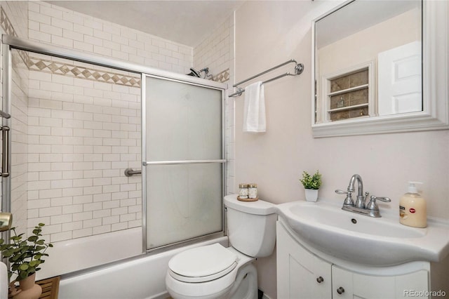 full bathroom with vanity, toilet, and combined bath / shower with glass door