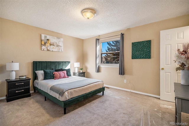 bedroom with light carpet and a textured ceiling