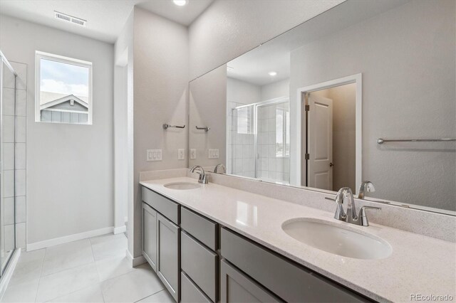 14145 Deertrack Ln, Parker, CO 80134 - full bath featuring a shower stall, double vanity, tile patterned flooring, and baseboards