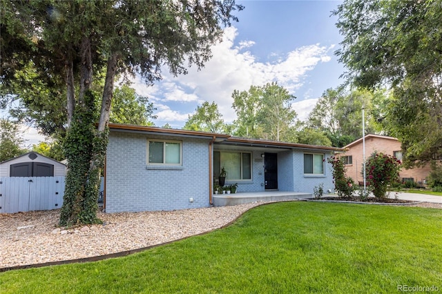 7650 W 24th Ave, Lakewood, CO 80214 - ranch-style home with brick siding, a front lawn, a patio area, and a storage unit