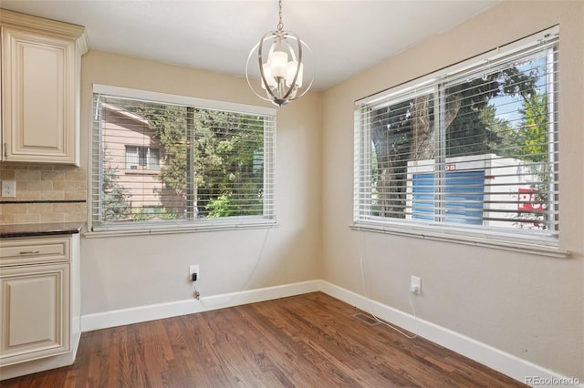 7650 W 24th Ave, Lakewood, CO 80214 - unfurnished dining area with a chandelier and dark wood-style floors