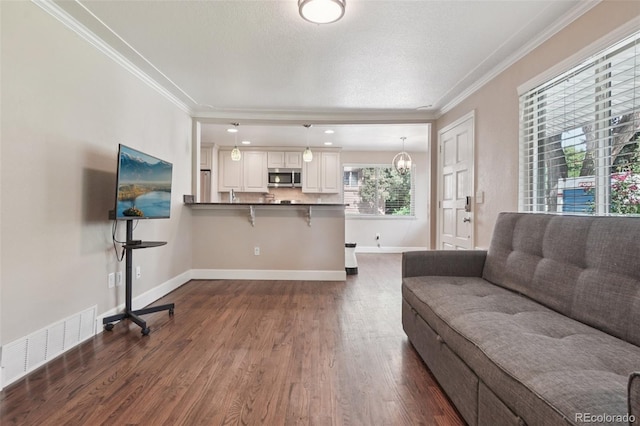 7650 W 24th Ave, Lakewood, CO 80214 - living area featuring crown molding and dark wood finished floors