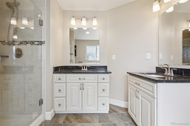 7650 W 24th Ave, Lakewood, CO 80214 - bathroom featuring a stall shower and two vanities