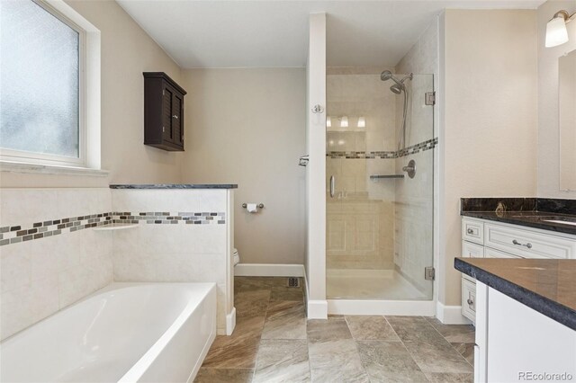 7650 W 24th Ave, Lakewood, CO 80214 - bathroom with vanity, a stall shower, and a bath