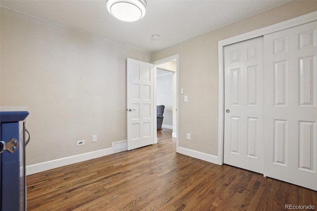 7650 W 24th Ave, Lakewood, CO 80214 - unfurnished bedroom with wood finished floors and a closet