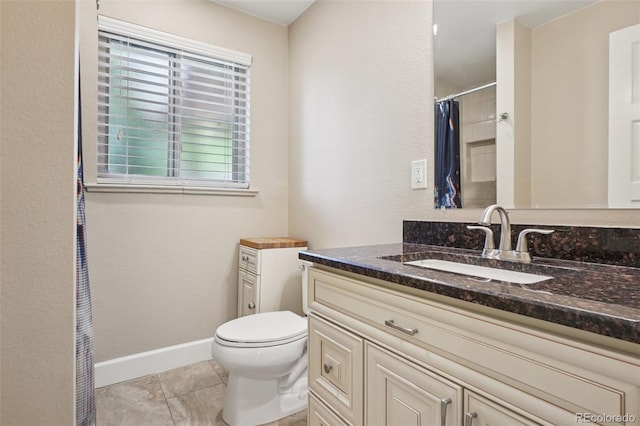 7650 W 24th Ave, Lakewood, CO 80214 - full bath featuring vanity, a shower with shower curtain, and tile patterned floors