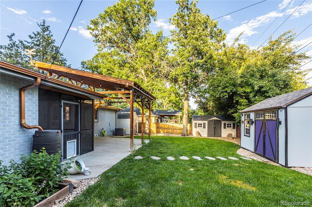 7650 W 24th Ave, Lakewood, CO 80214 - view of yard featuring a storage unit, a patio, and a sunroom
