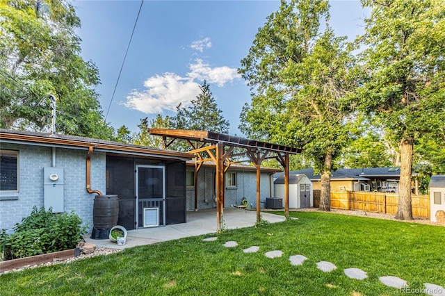 7650 W 24th Ave, Lakewood, CO 80214 - back of house featuring a storage unit, a patio, a sunroom, and brick siding