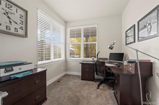 office area with light colored carpet, baseboards, and visible vents