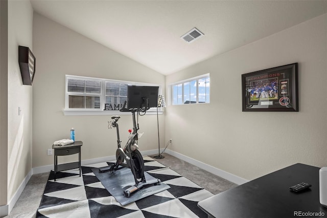 workout area featuring visible vents, baseboards, carpet floors, and vaulted ceiling