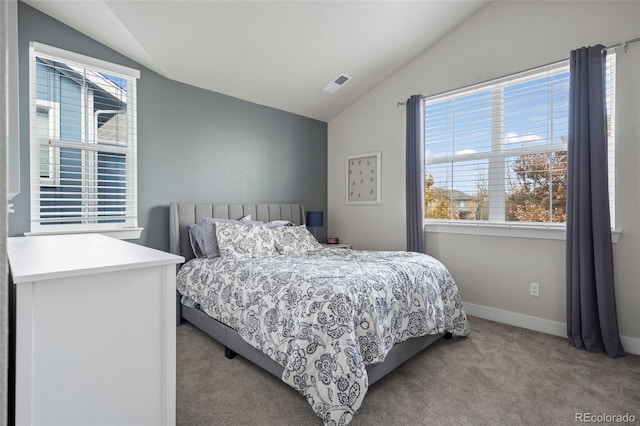 carpeted bedroom featuring multiple windows, visible vents, and lofted ceiling