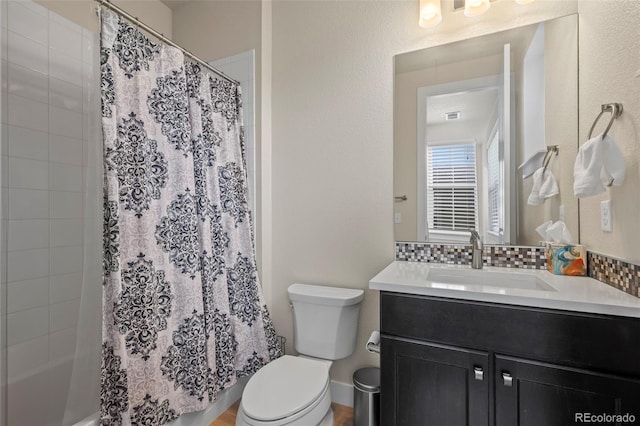 bathroom featuring toilet, visible vents, decorative backsplash, and vanity