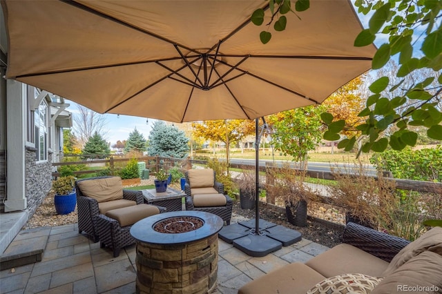 view of patio / terrace with an outdoor fire pit and fence