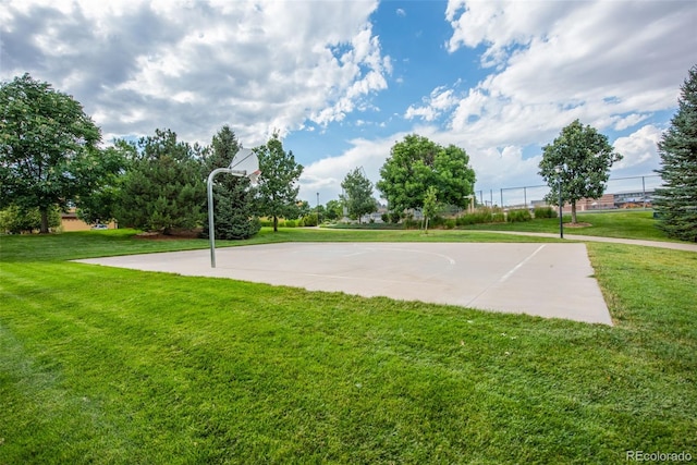 view of sport court featuring a lawn and community basketball court