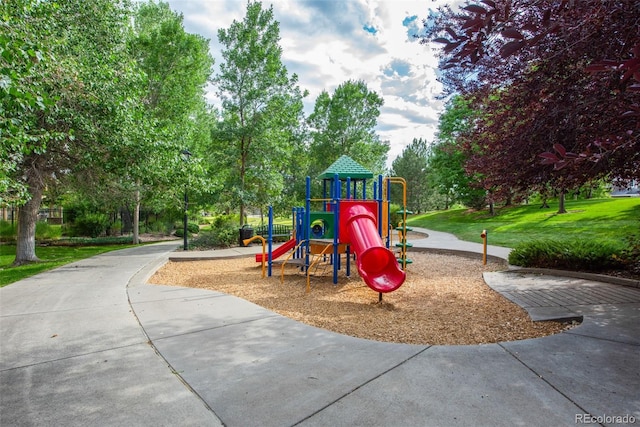 communal playground featuring a lawn
