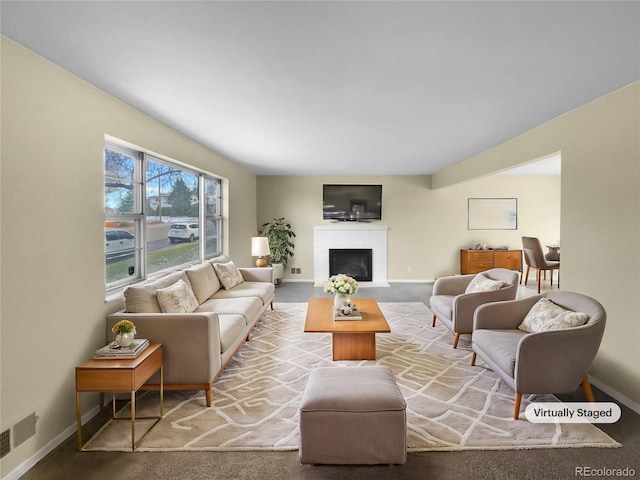 living room with carpet flooring and a fireplace