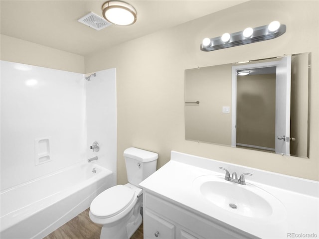 full bathroom featuring toilet, wood-type flooring, shower / washtub combination, and vanity