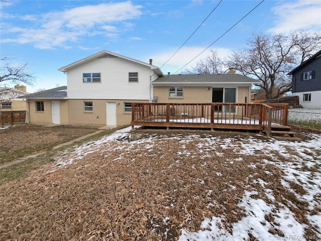 snow covered property with a wooden deck