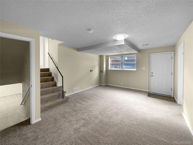 basement featuring carpet and a textured ceiling