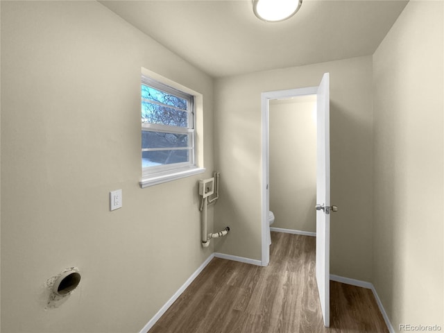 laundry area with dark hardwood / wood-style flooring