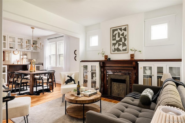 4224 N Clay St, Denver, CO 80211 - living room with a chandelier, a high end fireplace, and wood finished floors