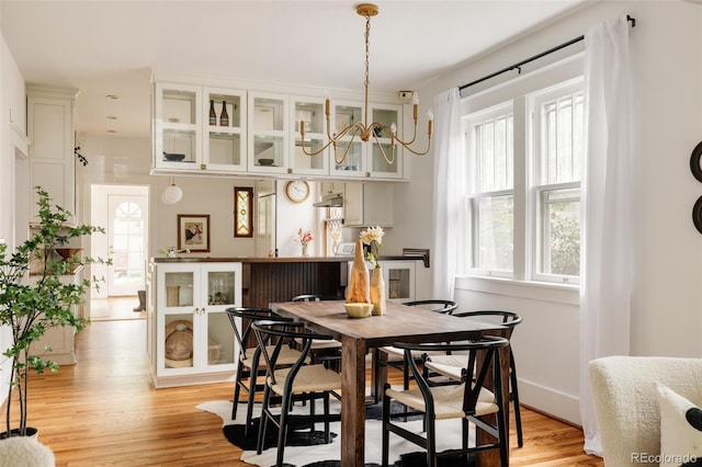 4224 N Clay St, Denver, CO 80211 - dining room featuring light wood finished floors, plenty of natural light, and a chandelier
