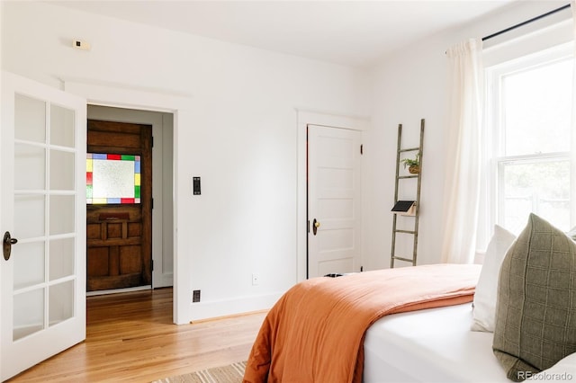 4224 N Clay St, Denver, CO 80211 - bedroom with light wood-type flooring, baseboards, and french doors