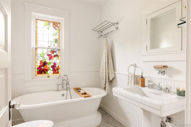 4224 N Clay St, Denver, CO 80211 - full bathroom featuring wainscoting, a freestanding tub, and a sink