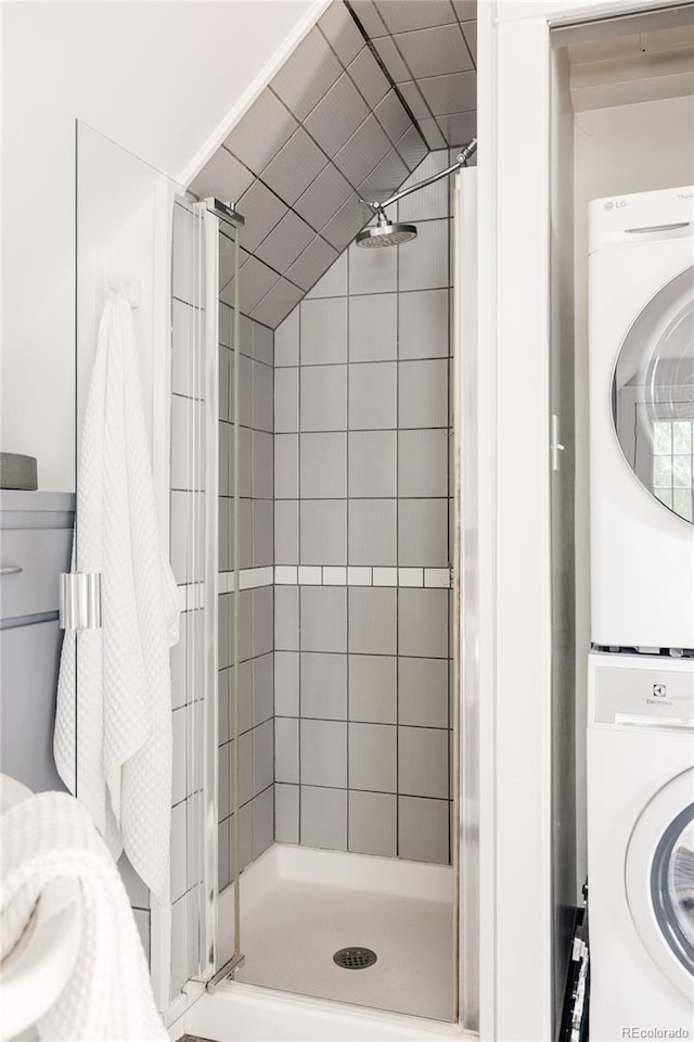 4224 N Clay St, Denver, CO 80211 - bathroom with stacked washing machine and dryer, a stall shower, and vaulted ceiling