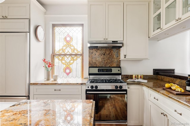 4224 N Clay St, Denver, CO 80211 - kitchen featuring stainless steel range with gas cooktop, under cabinet range hood, healthy amount of natural light, and glass insert cabinets