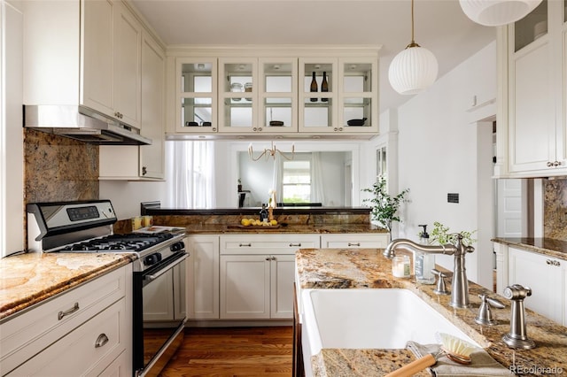 4224 N Clay St, Denver, CO 80211 - kitchen featuring stainless steel range with gas cooktop, under cabinet range hood, hanging light fixtures, a sink, and white cabinetry