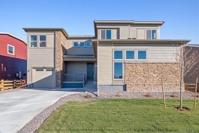 view of front of house featuring a garage and a front lawn