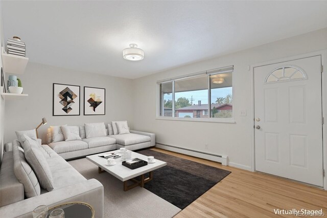 8467 W 62nd Pl, Arvada, CO 80004 - living area featuring light wood-style floors and a baseboard radiator