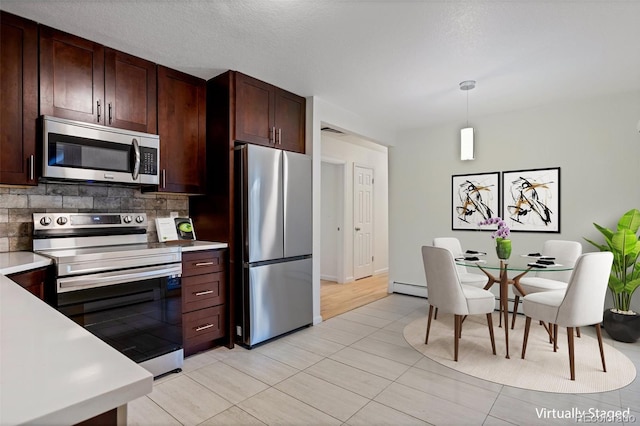 8467 W 62nd Pl, Arvada, CO 80004 - kitchen featuring tasteful backsplash, dark brown cabinets, light countertops, a baseboard heating unit, and stainless steel appliances
