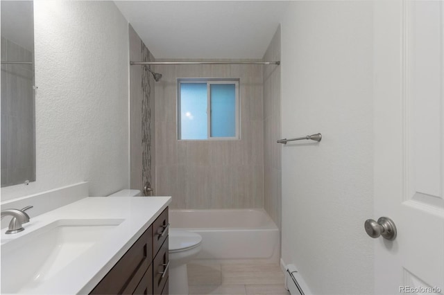 full bathroom featuring tiled shower / bath, vanity, and toilet