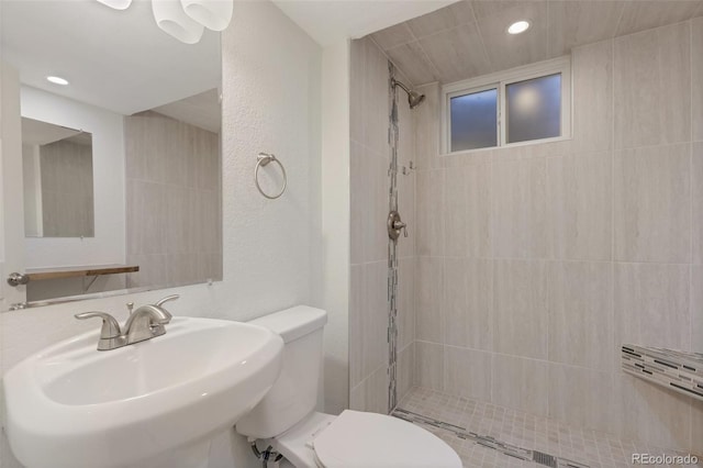 8467 W 62nd Pl, Arvada, CO 80004 - full bathroom featuring toilet, recessed lighting, a tile shower, and a sink