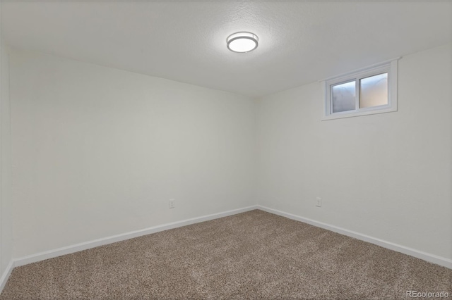 unfurnished room with a textured ceiling and carpet floors