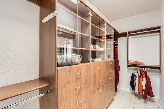spacious closet with light tile patterned floors