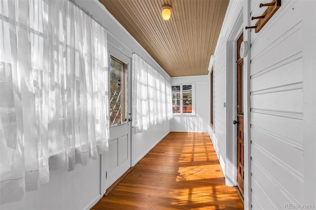 hallway featuring wooden ceiling and wood-type flooring