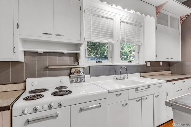 kitchen with white cabinetry, white range with electric stovetop, and tasteful backsplash