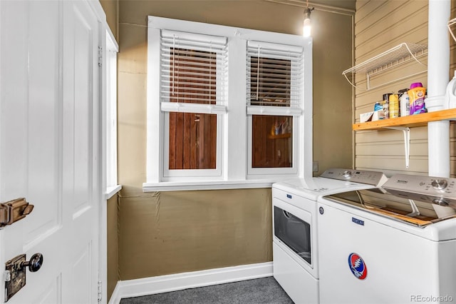 laundry room featuring dark carpet and separate washer and dryer