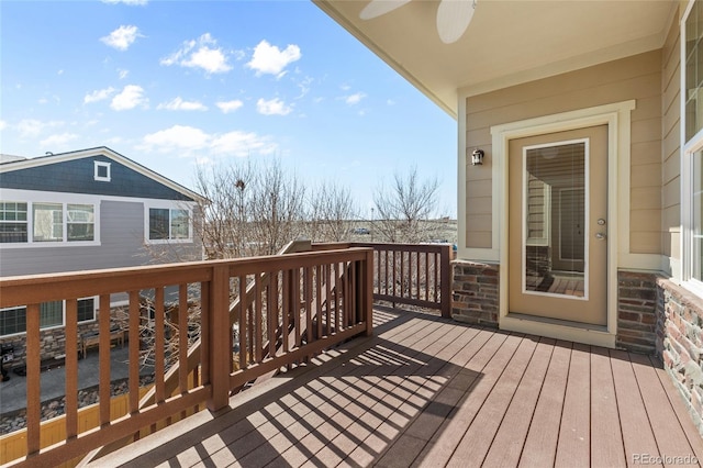 wooden terrace featuring a ceiling fan