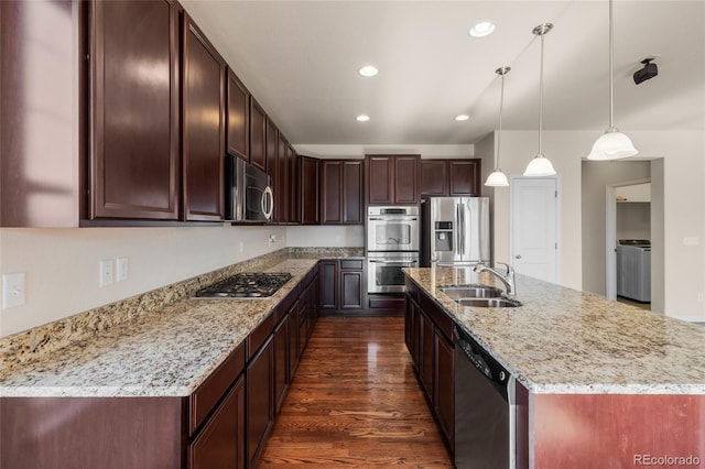 kitchen with light stone counters, recessed lighting, stainless steel appliances, a sink, and dark wood-style floors