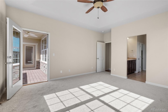 unfurnished bedroom featuring light carpet, baseboards, and french doors