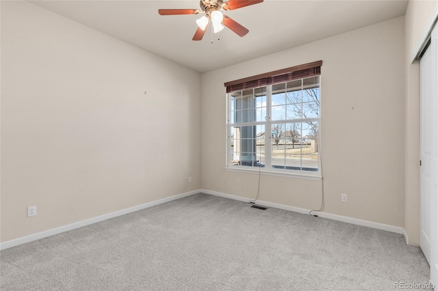 unfurnished room featuring ceiling fan, carpet, and baseboards